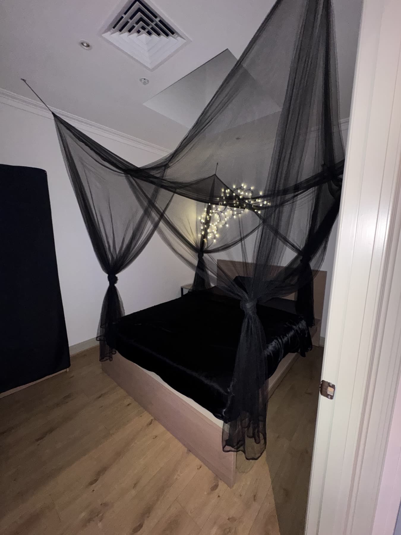 Black canopy over black satin