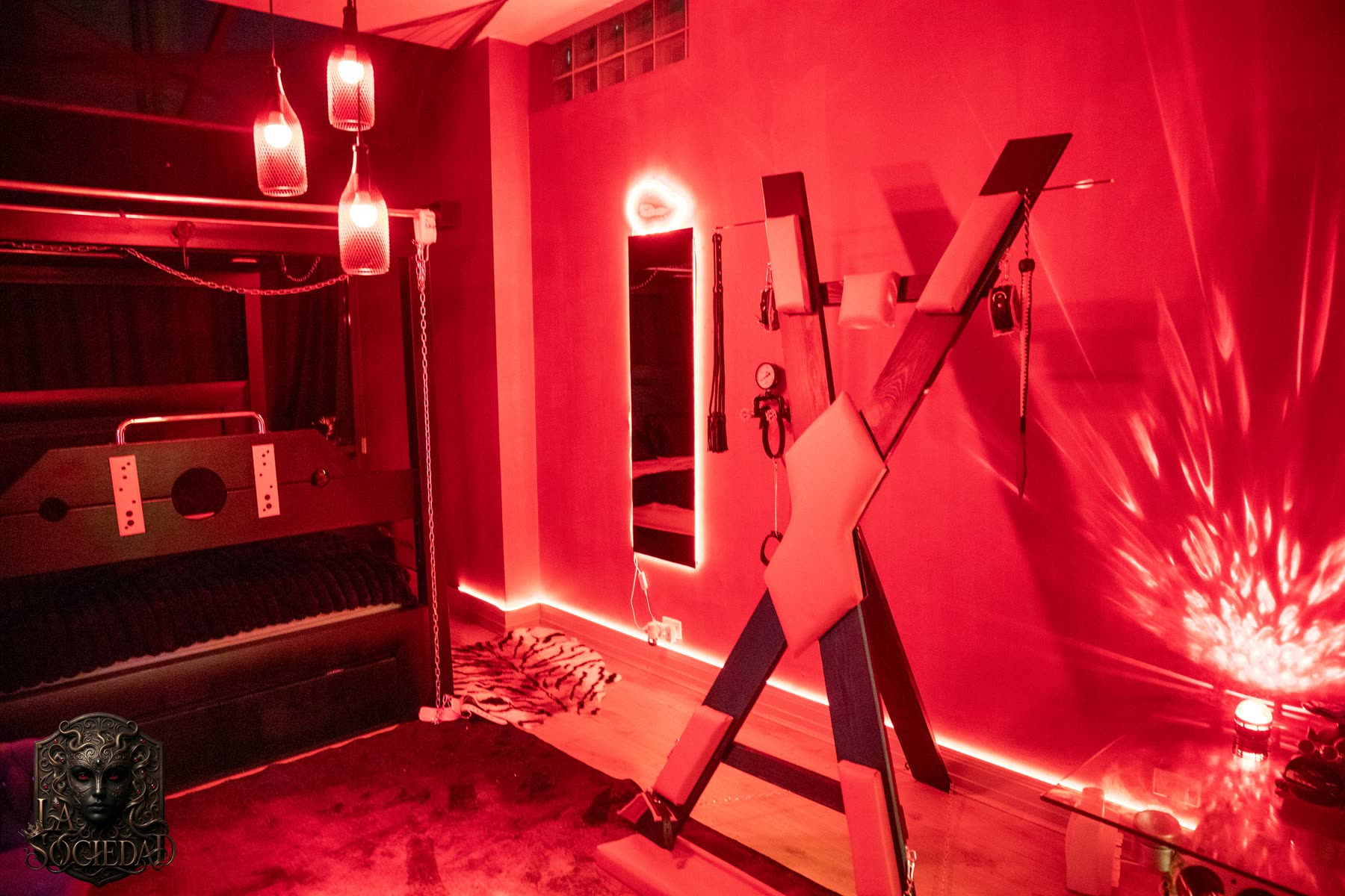 The Red Room: the cross, the stocks and the bed behind them